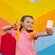 A young girl taking a selfie in front of a mural